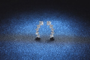 Macro shot of curved S925 sterling silver studs with five sparkling round moissanite stones