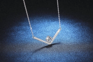 Close-up of V-shaped sterling silver pendant featuring a brilliant 1-carat moissanite stone