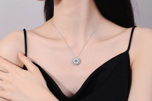 Close-up of S925 silver necklace with white shell pendant and sparkling moissanite stone
