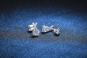 Macro shot of S925 sterling silver X-shape stud earrings with brilliant moissanite stones