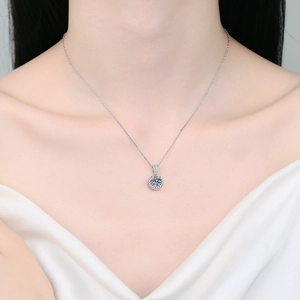 S925 sterling silver necklace featuring 1 carat round moissanite pendant on a model