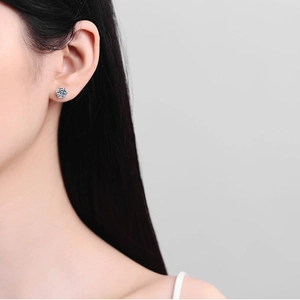 Classic 925 sterling silver six-claw moissanite stud earrings worn by a model