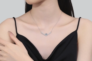 Close-up of V-shaped 925 silver necklace with moissanite pendant on model neck