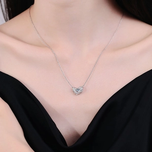 S925 sterling silver Guardian Wings necklace with Moissanite heart pendant on a model