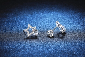 Macro detail of S925 sterling silver star stud earrings with 1 carat moissanite and butterfly back