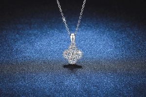 Detailed view of s925 silver moissanite four-leaf clover pendant on a dark starry background