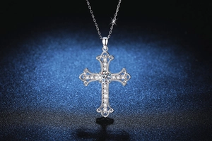 Macro view of S925 silver cross pendant with moissanite stones and intricate filigree