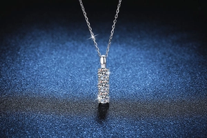 Macro detail of three-stone Moissanite pendant necklace with high polish S925 silver finish