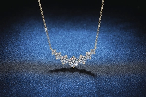 Macro detail of a 1.7ct D color moissanite necklace with seven-stone gradient gold pendant