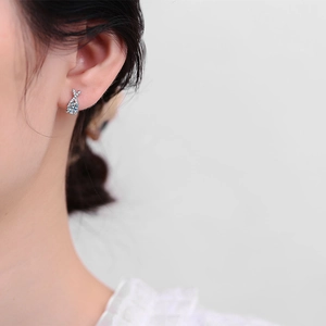 Elegant S925 sterling silver X-shaped earrings with 0.5ct D-color Moissanite on female model