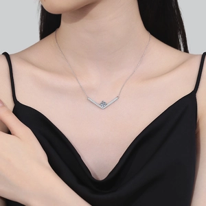 925 silver V-shaped moissanite pendant necklace worn on a black silk dress model
