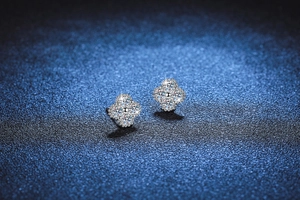 Macro shot of silver S925 four-leaf clover stud earrings with paved moissanite stones