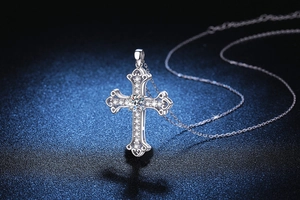 Macro shot of S925 silver cross pendant with brilliant moissanite and baroque curves