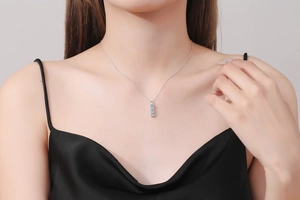 Detail of 925 silver necklace featuring three vertical light blue moissanite stones