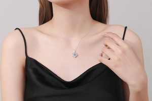 Close-up of S925 sterling silver heart pendant with 1 carat moissanite on neck