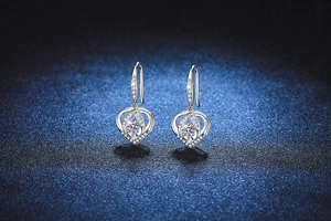 Macro view of heart-shaped S925 sterling silver earrings with moissanite stones