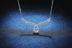 Close-up of S925 silver angel wing pendant featuring a 1-carat moissanite centerpiece