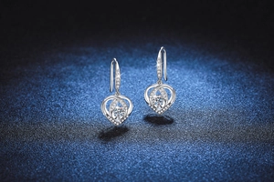 Macro view of S925 sterling silver heart-shaped earrings with round moissanite