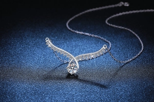 Detailed macro view of S925 sterling silver angel wing pendant with 1ct moissanite diamond