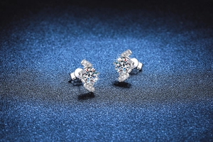Macro view of S925 sterling silver four-prong stud earrings with brilliant moissanite