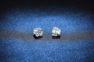 Macro shot of 925 sterling silver six-prong moissanite stud earrings with side hollow details