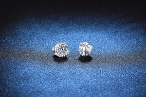 Macro detail of round moissanite stud earrings in S925 silver with magnetic back