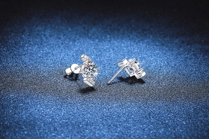 Macro detail of S925 sterling silver stud earrings featuring 4-claw moissanite setting