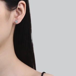 Classic S925 sterling silver pear cut moissanite stud earrings worn by a model