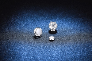 Detail view of magnetic Moissanite studs and polished silver backing for unpierced ears