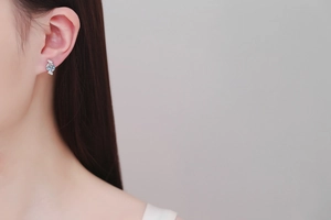 Close-up of S925 sterling silver moissanite stud earring worn on a female ear