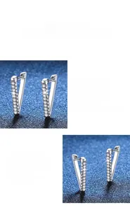 Macro detail of V-shaped 925 sterling silver earrings with inlaid moissanite stones