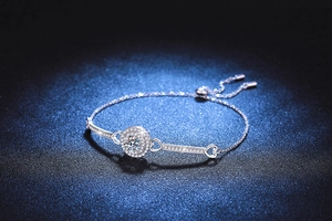 Close-up of 925 sterling silver bracelet with round moissanite and heart accents