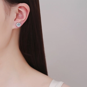 Elegant round moissanite stud earring in S925 sterling silver worn by a female model