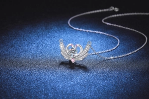 Close-up of S925 sterling silver swan necklace with pink stones and moissanite heart pendant