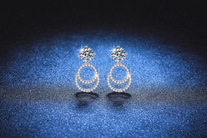 Macro shot of 925 silver moissanite earrings with double concentric pavé rings