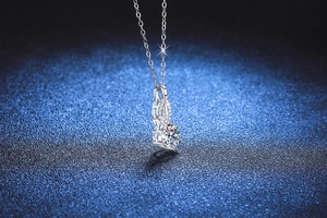 Macro shot of a 1 carat moissanite gourd pendant on a silver-tone necklace chain