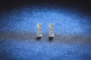 Close-up of S925 sterling silver studs with three vertically set Moissanite stones
