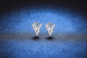 Macro detail of V-shaped S925 sterling silver studs with brilliant Moissanite stones
