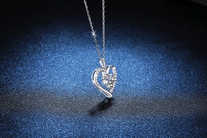 Macro shot of a S925 silver heart necklace with a round brilliant moissanite stone