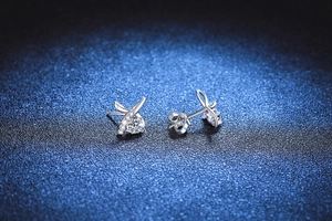 Macro shot of 925 sterling silver infinity earrings with brilliant moissanite stone