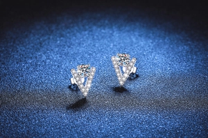 Close-up of V-shaped S925 silver earrings with brilliant moissanite and pave accents