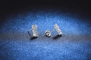 Macro shot of S925 sterling silver studs with three vertically set Moissanite gems