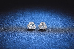 Macro view of S925 silver camellia earrings featuring a sparkling moissanite center