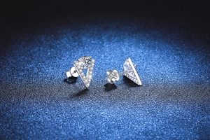 Close-up of S925 sterling silver V-shape earrings with moissanite stones and pavé accents