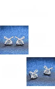 Macro detail of 925 sterling silver bow earrings with brilliant moissanite stone inlay