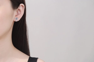 Close-up of S925 sterling silver V-shaped stud earring with moissanite on model