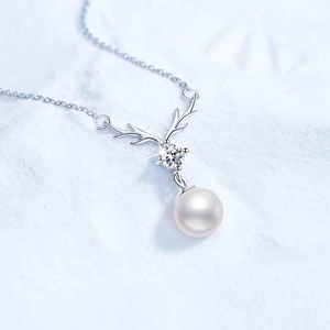S925 sterling silver deer antler necklace with pearl and moissanite on snow background