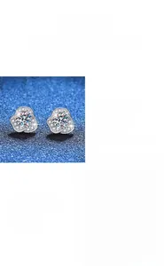 Macro detail of camellia and heart-shaped moissanite studs in S925 sterling silver