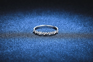 Macro detail of silver twist ring band featuring sparkling pavé set moissanite stones