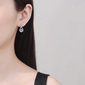 Elegant S925 sterling silver teardrop moissanite earrings shown on a model